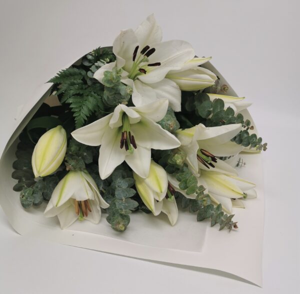 white scented lilies with green tones wrapped in white paper